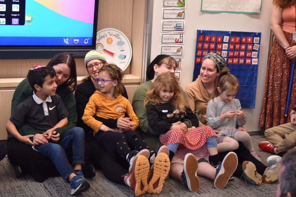 Hillel Torah 1st grade parents engaging with their children during Open Classroom, building parent-school connections and supporting student learning.